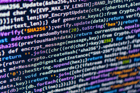 A close-up image of a computer monitor displaying unidentified code in a dark background, enhancing readability