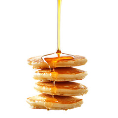 Floating pancakes with golden syrup cascading over them, placed on a plain white background,...