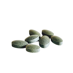 Several green pills placed on a plain white background, perfect for showcasing their sleek design and wellness-focused qualities