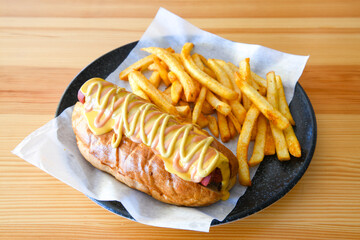 Traditional Brazilian sandwich of bread with sausage, tomato, onion and lettuce. Crispy salt bread with roasted or fried sausage.