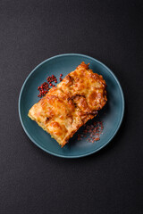 Lasagna or pasta layered with meat, cheese, salt, spices and herbs