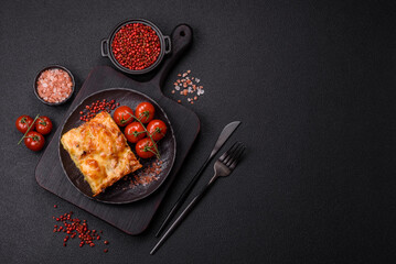 Lasagna or pasta layered with meat, cheese, salt, spices and herbs