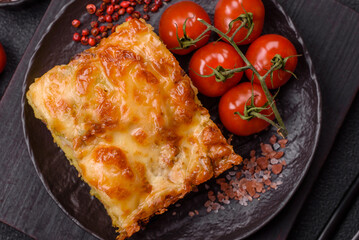 Lasagna or pasta layered with meat, cheese, salt, spices and herbs