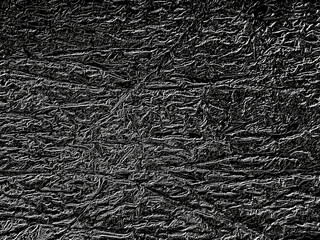 Black crumpled texture creating intriguing abstract pattern