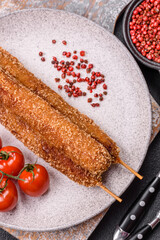 Lula kebab meat fried on a fire in breading with salt, spices and herbs