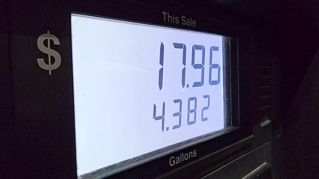 Fuel pump displays total gallons and cost during refueling at gas station