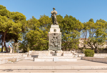 Obraz premium The Monument to the Fallen of all Wars in the public gardens of Augusta, province of Syracuse, Eastern Sicily.