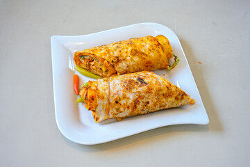 Lavash doner kebab ( soslu kasarli zurna doner durum )  or shawarma sliced in plate isolated.  Tavuk Et Doner Durum. Hatay Iskenderun usulu bazuka, zurna  tavuk doner durum. 