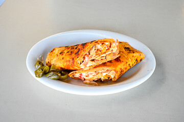 Lavash doner kebab ( soslu kasarli zurna doner durum )  or shawarma sliced in plate isolated.  Tavuk Et Doner Durum. Hatay Iskenderun usulu bazuka, zurna  tavuk doner durum. 