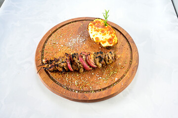 Famous Urfa meat liver, ciger wrapped by lavash with roasted chili pepper, onion and sauce in...