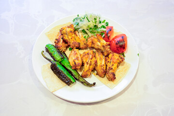 Chicken wings barbeque in a dish with BBQ grill sauce . Izgara tavuk kelebek sis kanat. Tavuk sis, gogus.