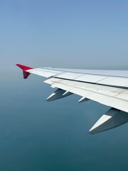 airplane left wing over the ocean