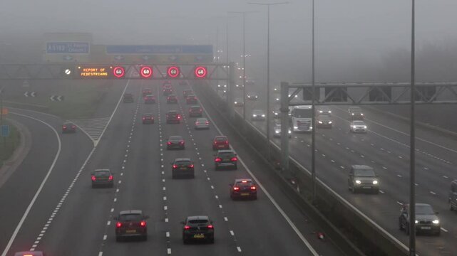 St Albans, UK, December 27, 2024. Road transport: Traffic on the British motorway M1 during a very foggy day.