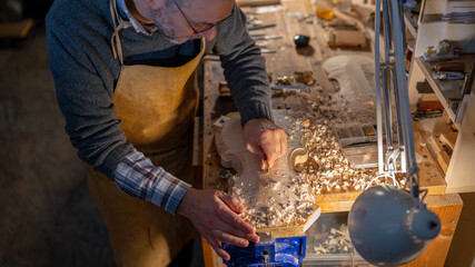 Luthier carefully crafting violin in cremona workshop