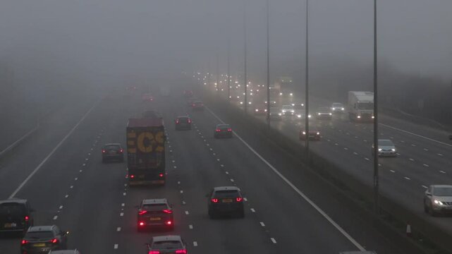 St Albans, UK, December 27, 2024. Road transport: Traffic on the British motorway M1 during a very foggy day.