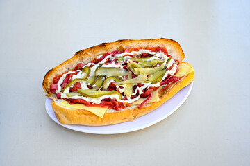 Close-up shot of Izmir's famous Turkish Traditional Kumru Sandwich, Ceşme Kumru, patso ingredients ready to eat salami, soudjouk, tomato, cheddar cheese and fried cheese. Yengen sandvic.