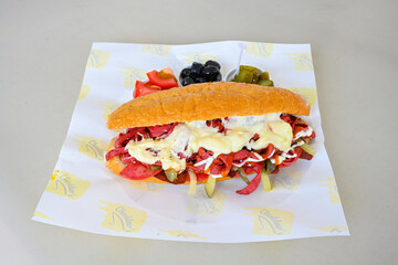 Close-up shot of Izmir's famous Turkish Traditional Kumru Sandwich, Ceşme Kumru, patso ingredients ready to eat salami, soudjouk, tomato, cheddar cheese and fried cheese. Yengen sandvic.