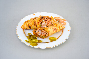 Lavash doner kebab ( soslu kasarli zurna doner durum )  or shawarma sliced in plate isolated.  Tavuk Et Doner Durum. Hatay Iskenderun usulu bazuka, zurna  tavuk doner durum. 