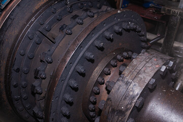 Close-up of a bolted steel connection of a ship's propeller shaft.