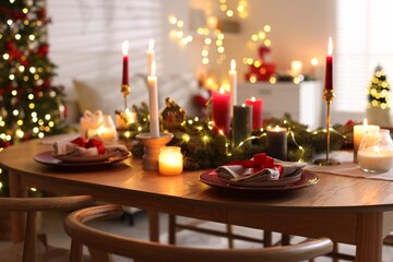 Festive table setting in room decorated for Christmas. Bokeh effect