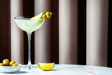 Mexican martini, alcoholic cocktail drink with tequila, liqueur, lime juice and green olives....
