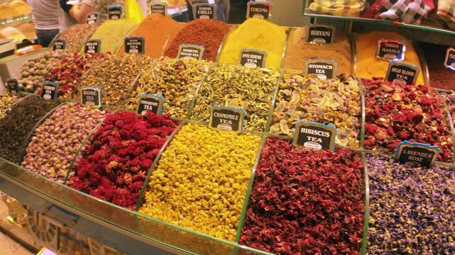 Footage of the Egyptian or Spice Bazaar in Istanbul, the shot moves over various tea and spices