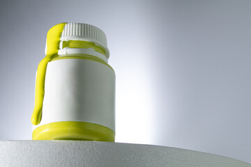 Rapeseed-yellow liquid dripping from bottle