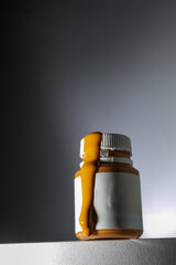 orange acrylic pours out of the bottle, acrylic for painting on canvas