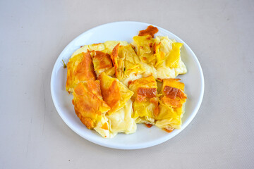 Turkish style meat stuffed filo dough borek served kol boregi.Cheese and minced pie are sliced on a marble background. Turkish name: Kol Boregi, kiymali, peynirli su boregi. Ci borek. Kafkas cig borek