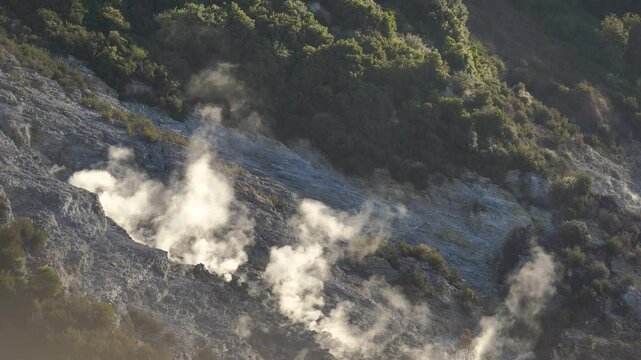 Steam vents in the volcanic terrain of the Phlegraean Fields near Pozzuoli, a geologically active Italian region.