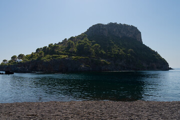 The beautiful green island of Isola di Dino in Praia a Mare, Calabria, Italy. In the foreground the...