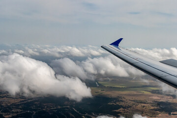 Airplane wing and winglet over clouds in the south eastern United States 