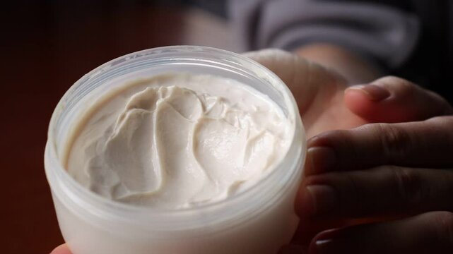 Hand cream close-up. Hand cream texture on women's fingers. Beauty routine