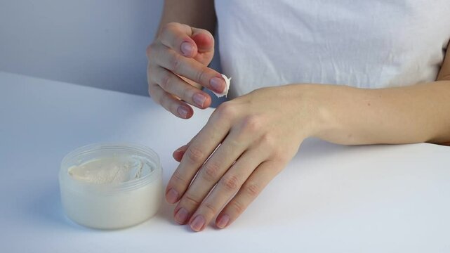 Female hands applying hand cream. Hand massage. Close-up.