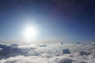 Naklejka premium background of blue sky with sun and clouds. Clouds and sun over the sky. Beautiful sunset