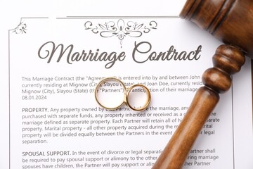 Marriage contract, gavel and golden rings, top view