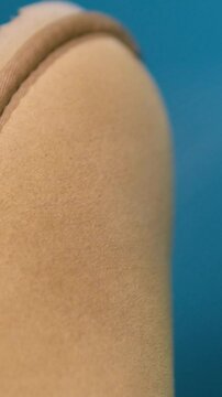 beige ugg boots Applying a water-repellent hydrophobic spray to white women's sneakers. Protection of shoes from moisture, dirt and unpleasant odor.