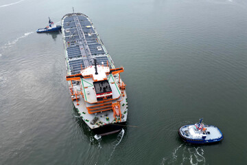A large oil tanker and tugs in the port of Rotterdam