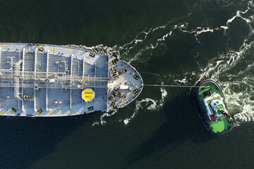 A large oil tanker and tugs in the port of Rotterdam