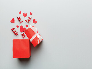 Happy valentines day decoration with opened gift box and heart on silver background