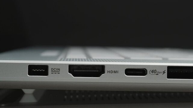 Slider Shot of a Laptop&rsquo;s Side Panel Showcasing DCIN, HDMI, USB-C, USB-A, and Headphone Jack Ports with Speed Labels, Emphasizing Advanced Connectivity and Functional Design.