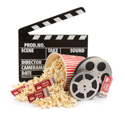Tasty popcorn, film reels, clapper and movie tickets isolated on white
