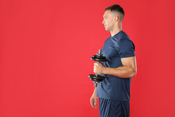 Man exercising with barbell on red background, space for text