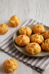 Homemade French Mini Cream Puffs on a Plate, side view.