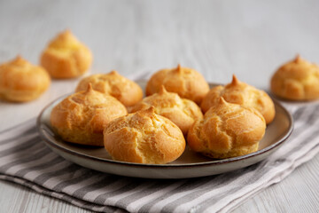 Homemade French Mini Cream Puffs on a Plate, side view.