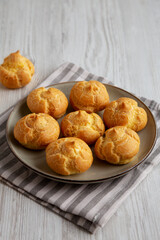 Homemade French Mini Cream Puffs on a Plate, side view.