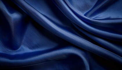 Obraz premium A dark blue fabric with smooth, flowing folds, creating a draped, abstract background.