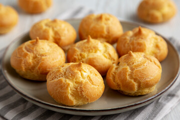Homemade French Mini Cream Puffs on a Plate, side view.