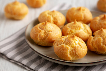 Homemade French Mini Cream Puffs on a Plate, side view.