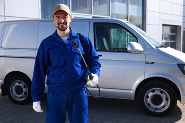 Pest control worker with spray tank outdoors